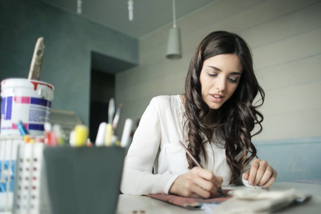 Woman Sitting While Holding Pen