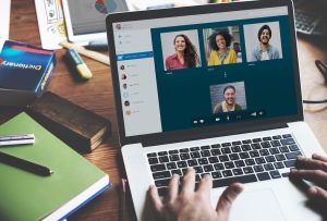 A diverse group of people on a conference call displayed on a laptop screen. Image represents ResultsResourcing's Virtual Business Potential Quiz found in its free tools.