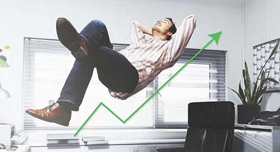 A photo of a relaxed man floating above his desk