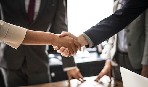 A photo of two people shaking hands suggesting one was hired and showing the simplicity behind hiring freelancers. 