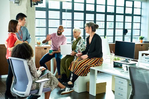 A group of freelance talent sits around discussing employment trends and a small business talent strategy. Freelancers are the key to scaling during the 2020 recession.