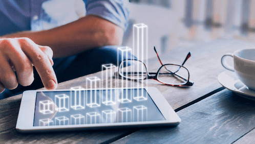 A business owner looks at a graph showing business growth experienced in the new year.