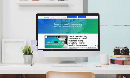 A computer sitting on a desk showing freelance recruiting platform ResultsResourcing's website.