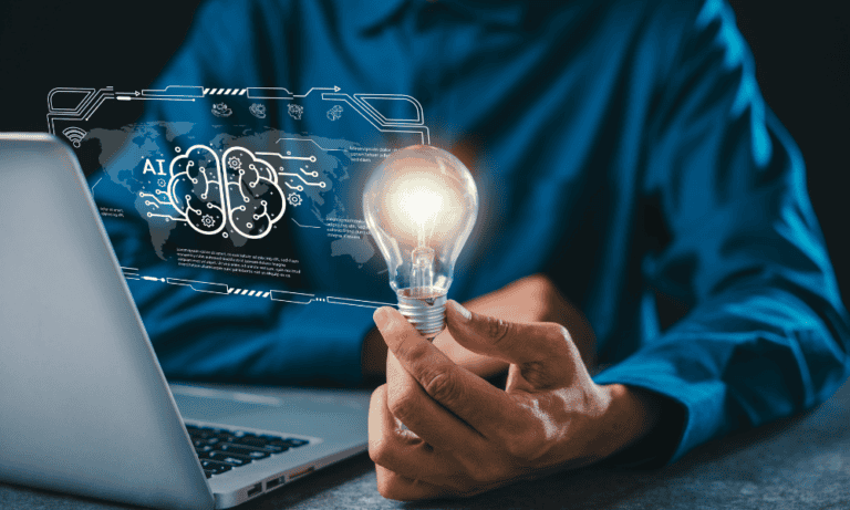 A man holding a lightbulb while on a computer suggesting a bridge between human and AI thinking to avoid AI workslop.